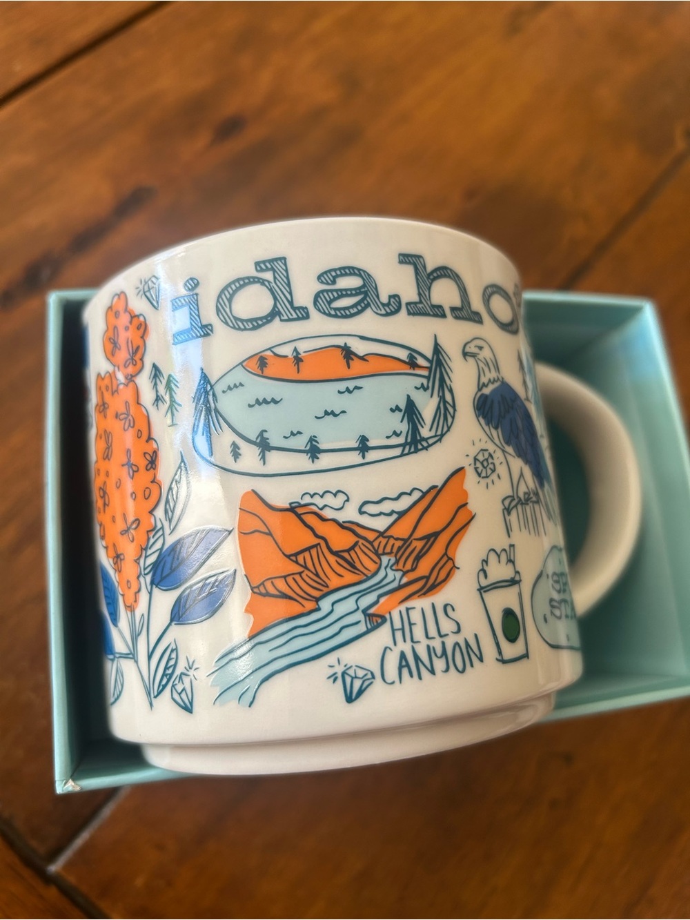 Starbucks Idaho Ceramic Mug in White, Orange & Blue